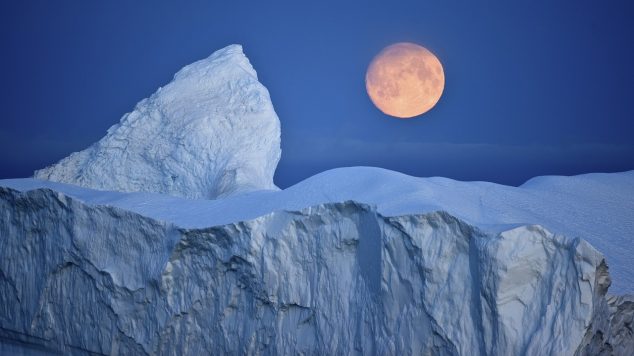 Image of Moon over iceberg