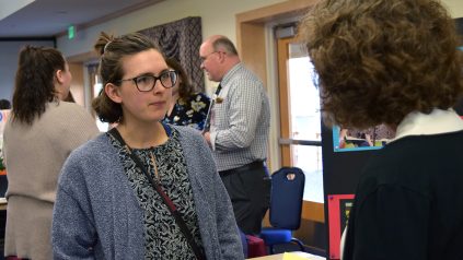 Natalie McCarthy, the 2023 outstanding graduating student in elementary education from the app College of Education and Human Development, talks to an employer at the college's 2023 education career fair.