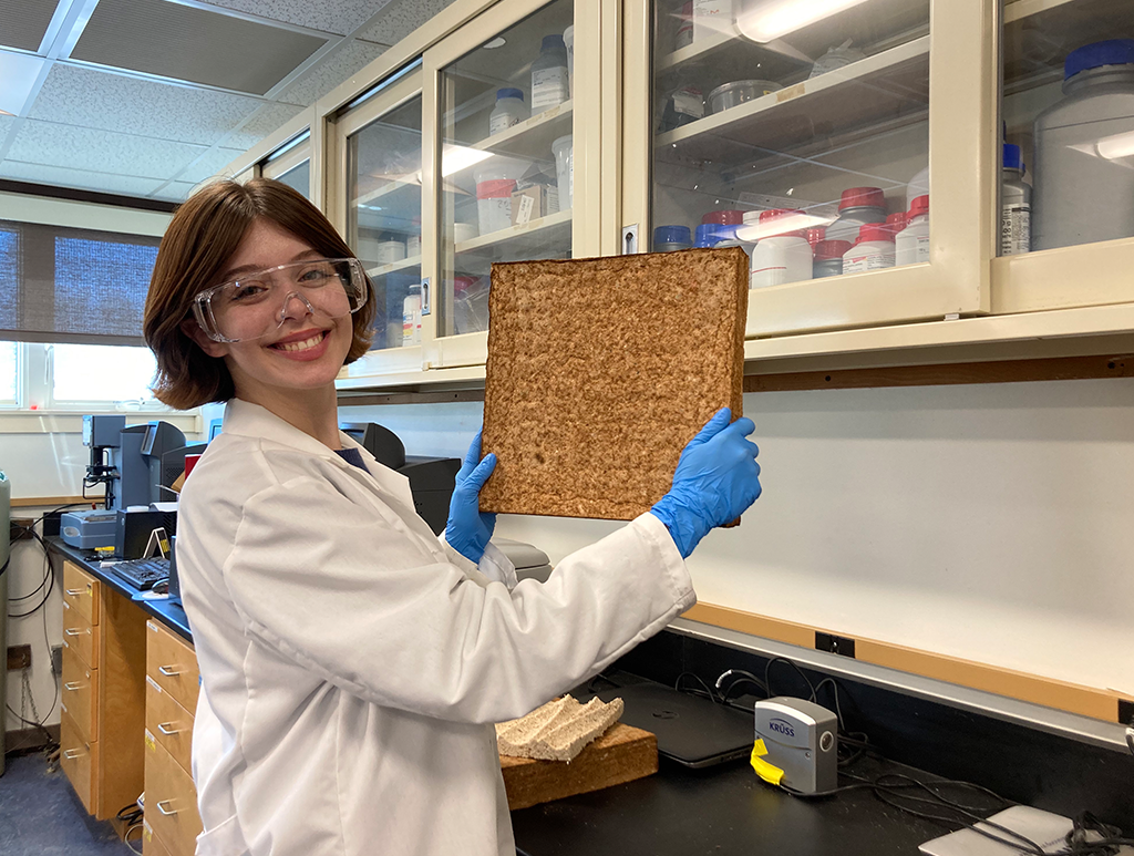 A photo of a student holding a slab of wood