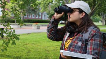 photo of student holding binoculars