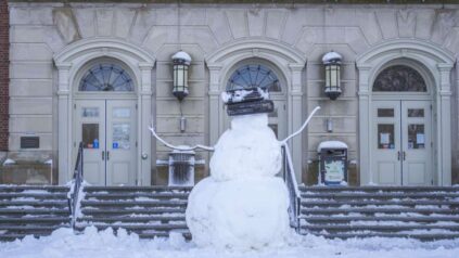 Snowman in front of Fogler Library