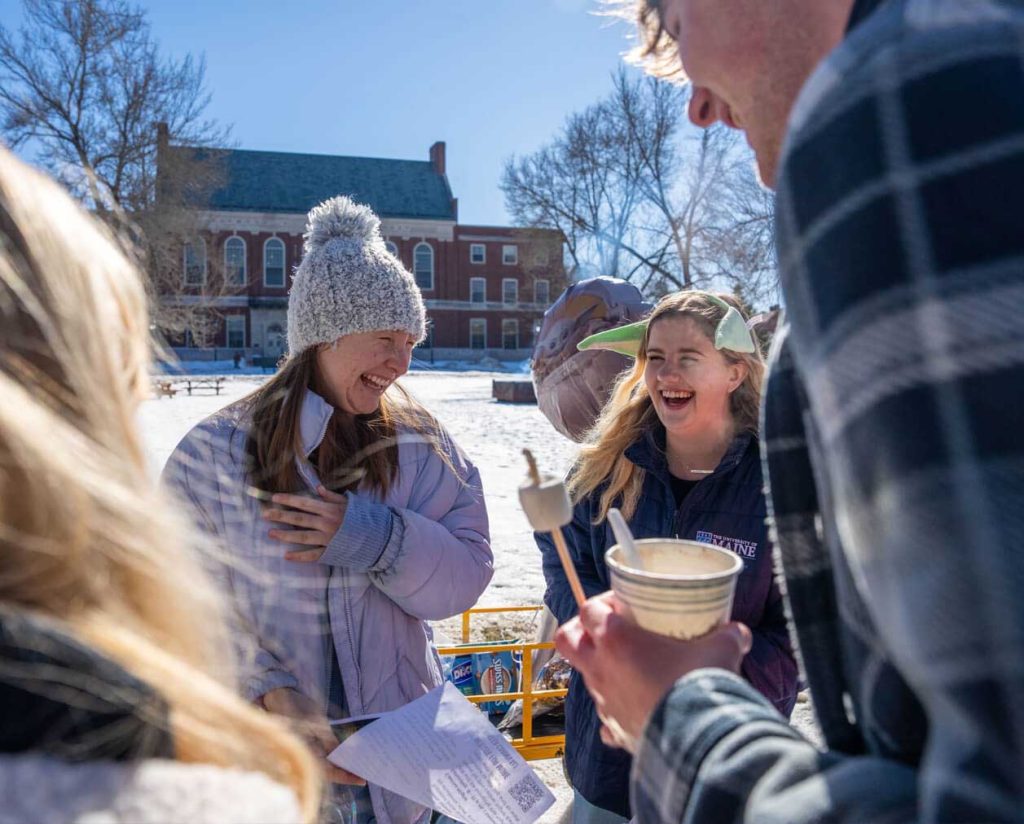 A photo of students having fun on UMaine's Mall in winter