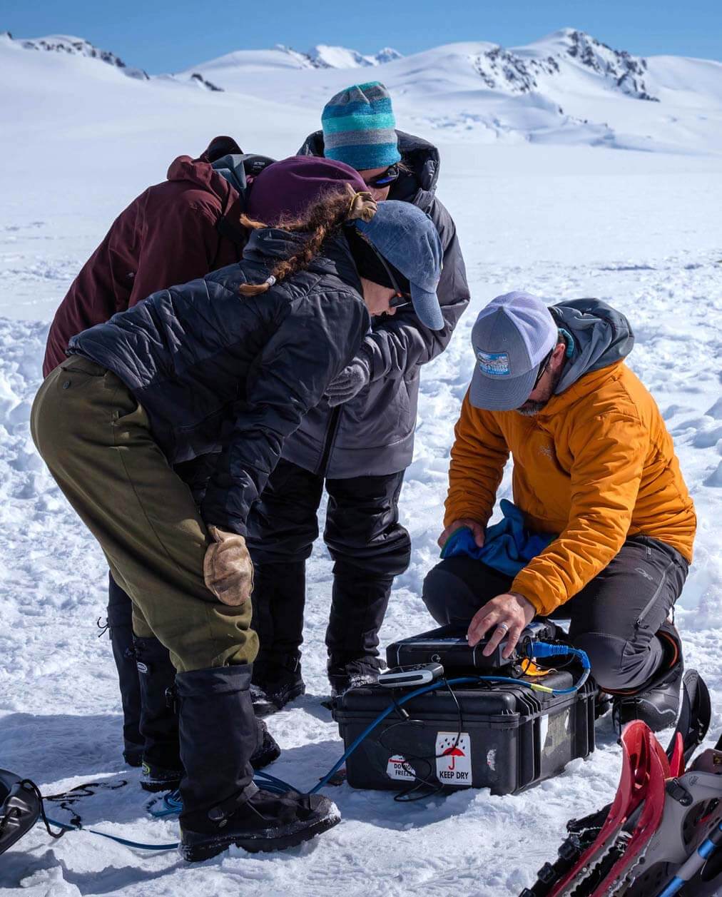 A photo of three people conducting fieldwork in the snow